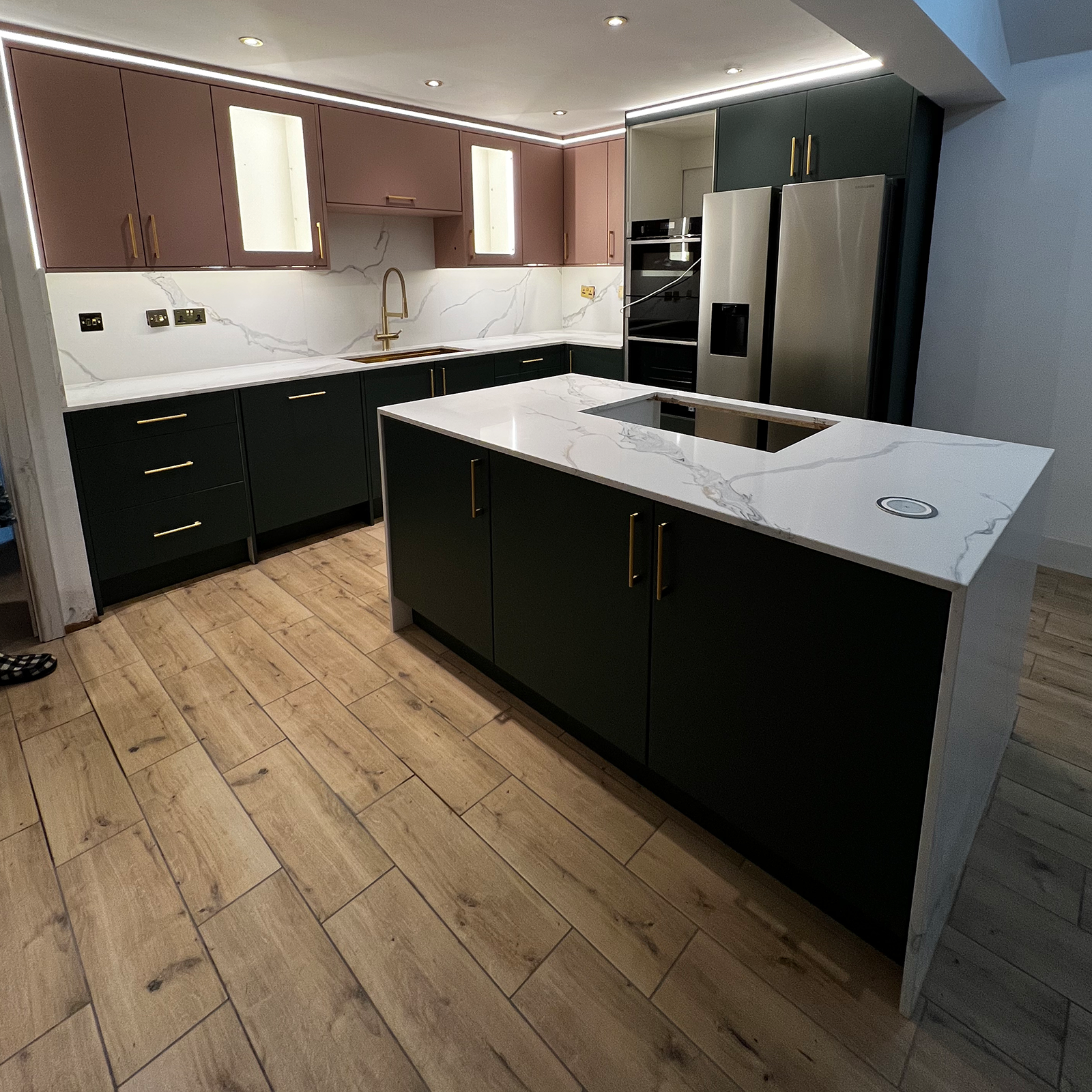 Luxury kitchen with marble surfaces, brass details and modern appliances