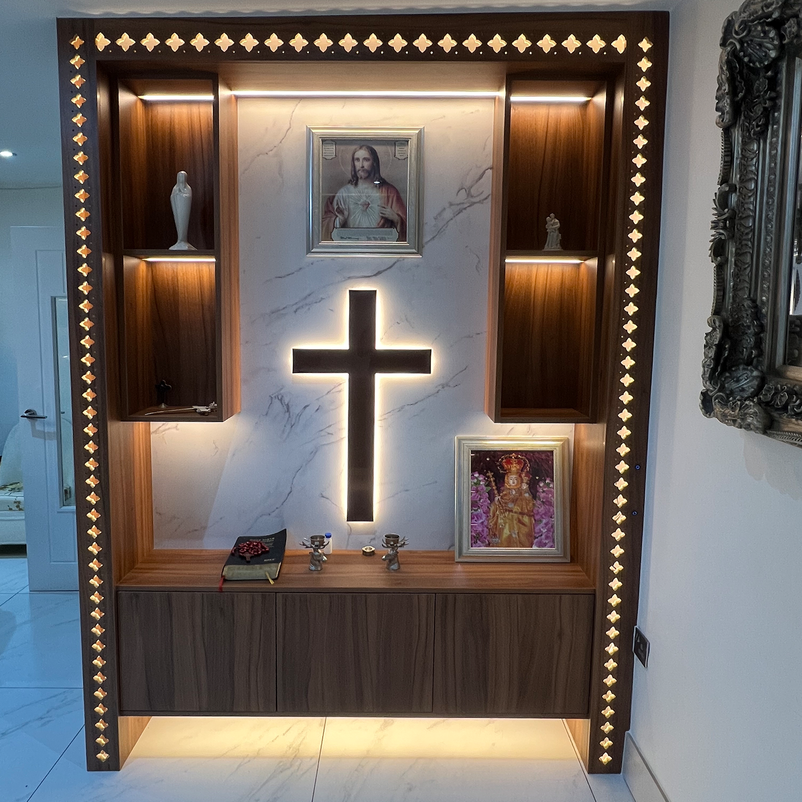 Modern home altar with illuminated cross and elegant wooden shelving