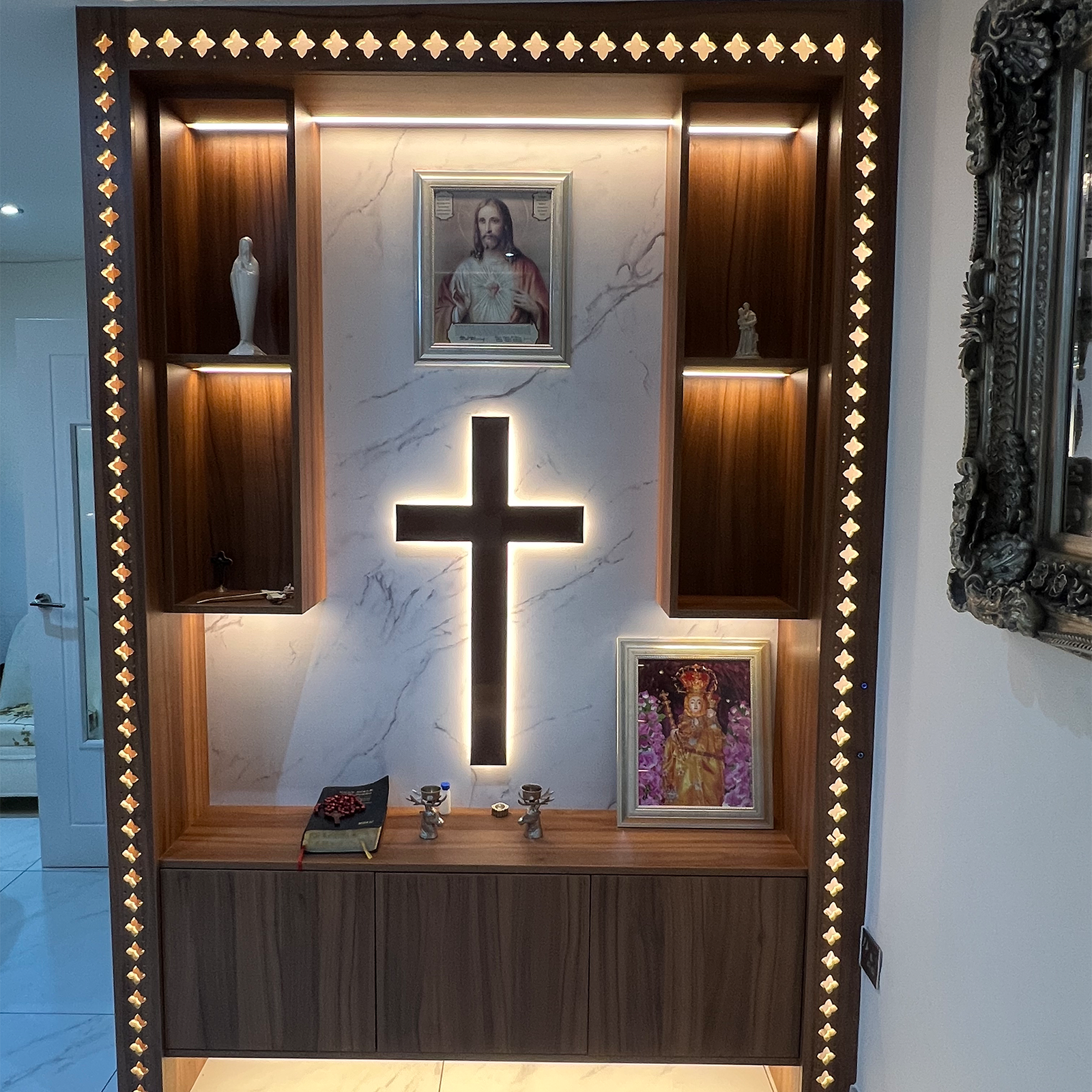Elegant devotional corner with marble backdrop and illuminated sacred cross